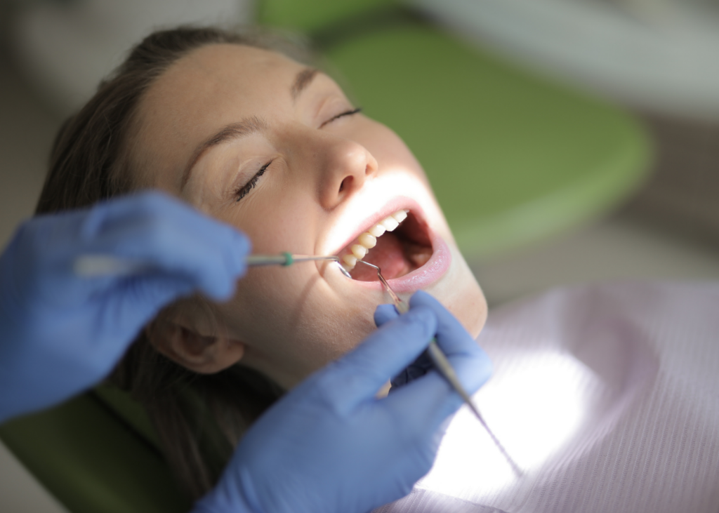 The dentist checking his female patient during general dentistry in Mississauga