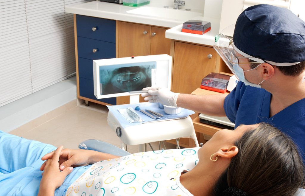 The dentist pointing the xray result from his patient for Bone & Gum Grafting in Misssissauga