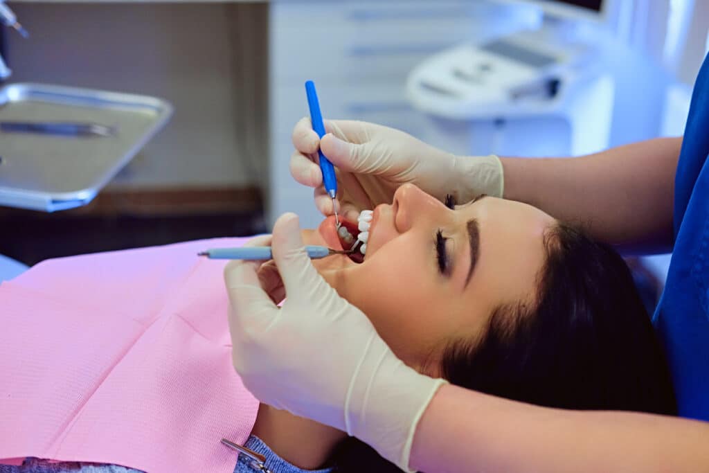 Dentist checking kid patient teeth for Cosmetic dental bonding in Mississauga, ON