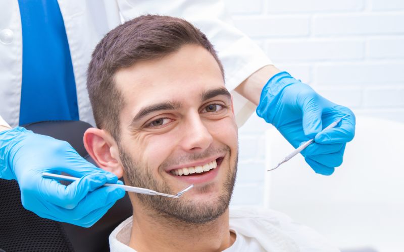  New Remove BG Cart Save Share Sample New Smiling young man at the dentist's office