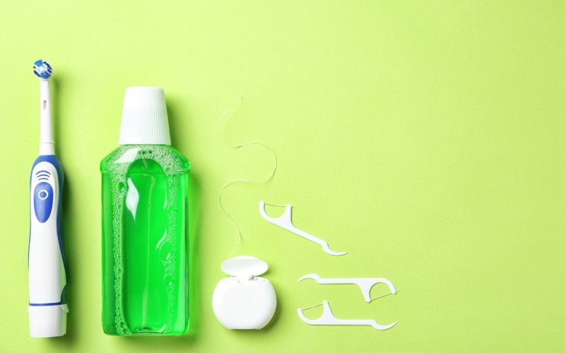 flat lay composition electric toothbrush oral hygiene products color background