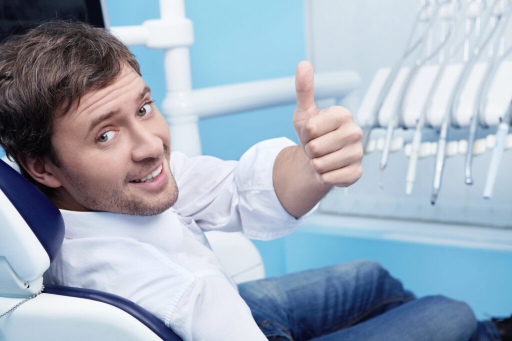 Young man sitting in dental chair for treatment